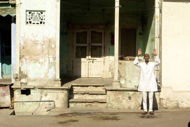 A man stands outside and engages in an early morning prayer. Photo by Jenna Belhumeur 