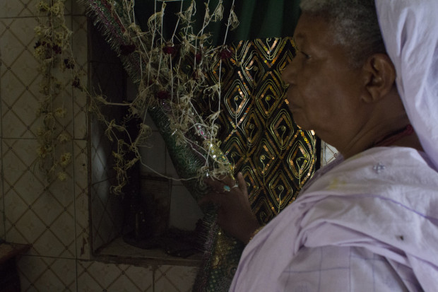 Rumanaben shows one of the niches in the walls of the shrine, where the Sidis light lamps every evening. Photo by Darcy Coulter.