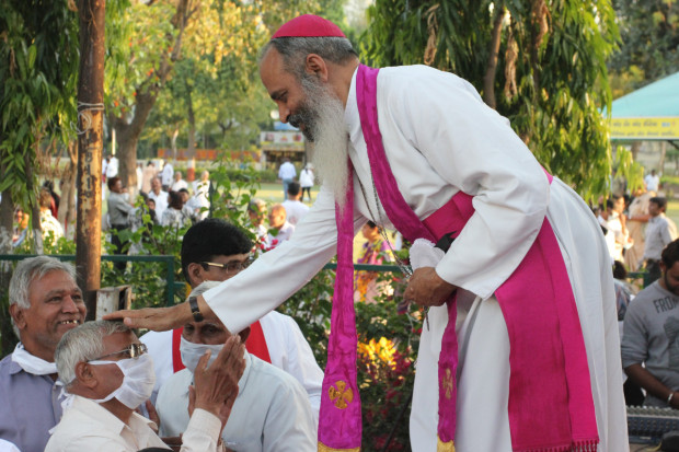Bishop Thomas Ignatius Macwan greeted locals following his prayer to close the rally in Ahmedabad. Macwan was appointed the Bishop of Ahmedabad in 2002. Photo by Arielle Dreher.