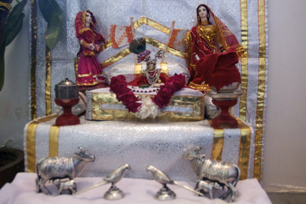 Solanki’s Lord Krishna image, surrounded by silver miniature animals, is dressed, fed, and sung to daily.
