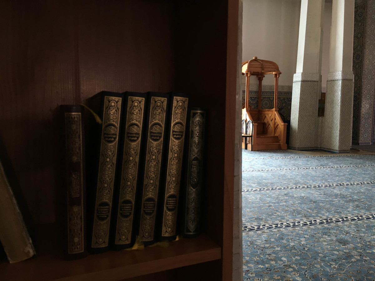 Several editions of the Qur'an, in Arabic, on bookshelves in the Grand Mosque of Rome. March 12, 2016. (Religio/Emily Neil)