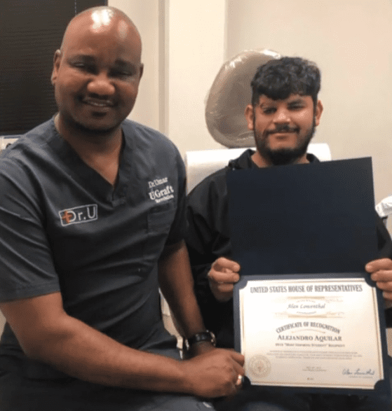 Alex displays his award with Dr.U at the Dr.U Hair and Skin Clinics in Los Angeles 
