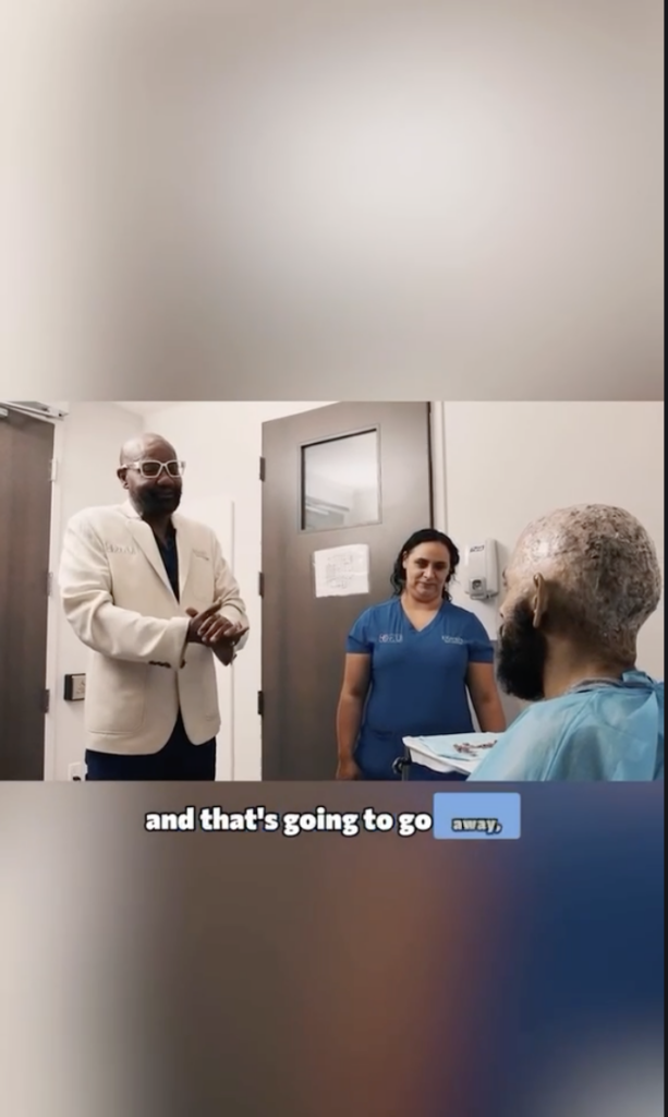 Dr. Sanusi Umar and a staff member speaking with Kevin in a clinical room.