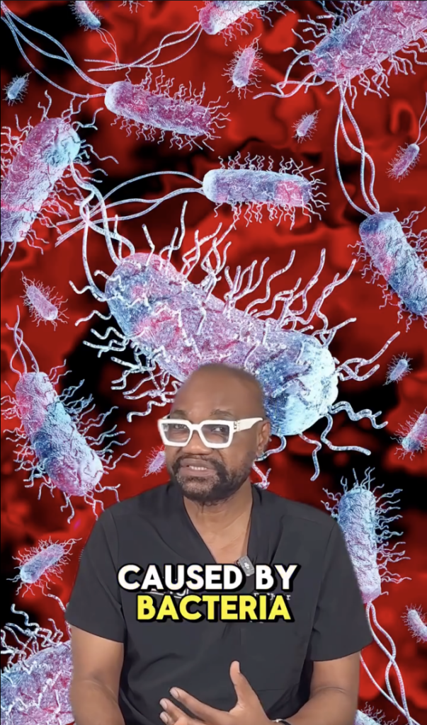Dr. Sanusi Umar seated in front of an illustrated bacteria background with on-screen text reading Caused by Bacteria.