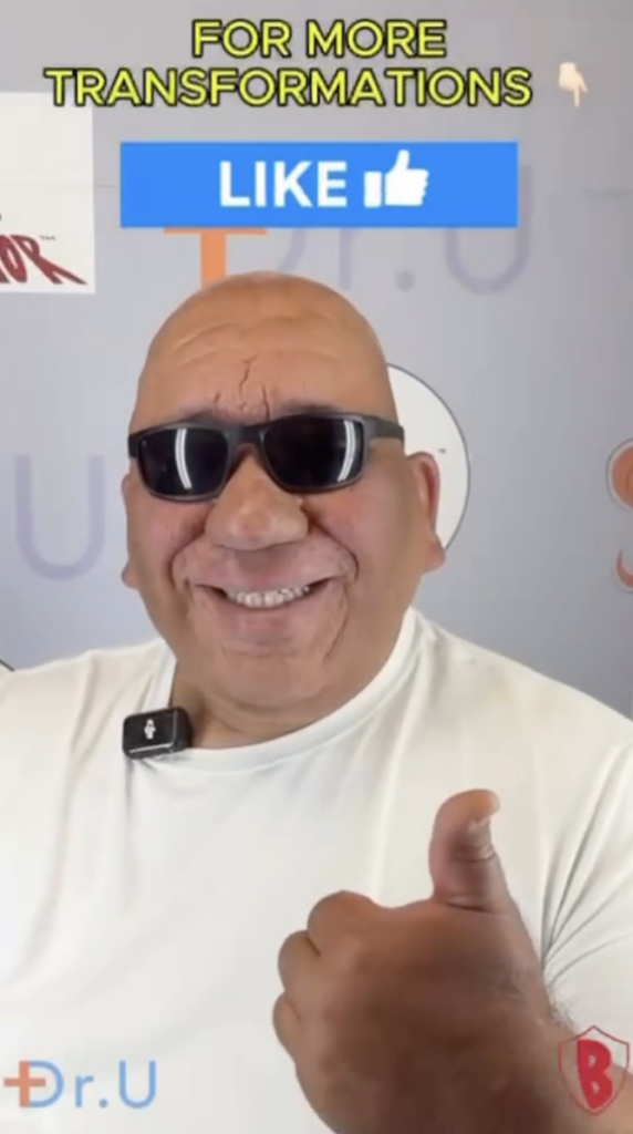 Robert wearing dark sunglasses and a white shirt, smiling and giving a thumbs-up.