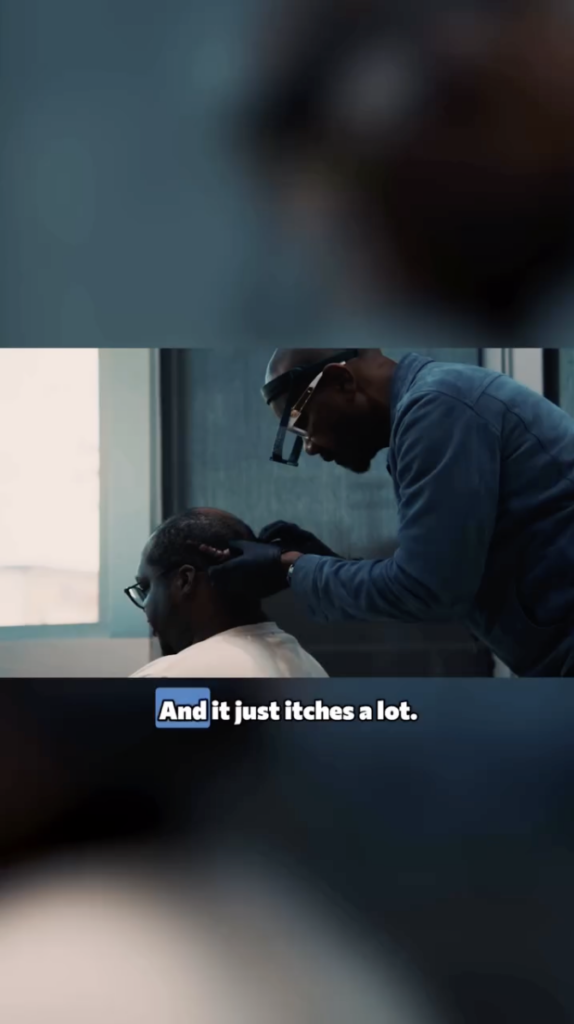 Dr. Sanusi Umar examining the back of Marcus’s head while Marcus is seated.