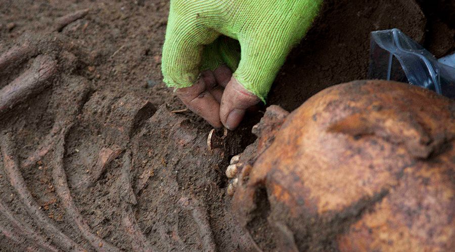 Archaeologists uncover the Trumpington Cross.