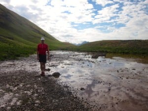 Trail runner muddy trail turning back San Juan Mountains