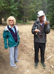 Andrew with his mom Brenda on Day 7, inspecting his hands which are raw from scrambling (Laura Hamilton)