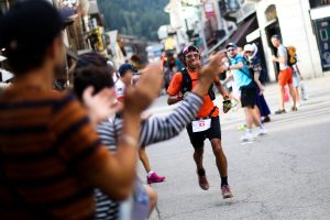 A runner finishing UTMB to cheering crowds