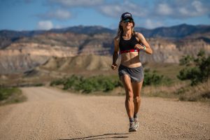 Best Women's Running Shorts - running on dirt road in shorts and sports bra