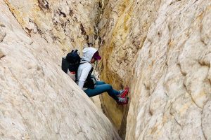 Best Running Tights for Women - stemming in a canyon slot wearing Patagonia Women's Endless Run 7/8 Tights