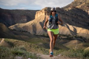 Best Running Tank Top for Women - wearing a tank top and hydration vest