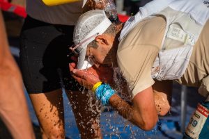 Best Running Gear for Hot Weather - Rod Farvard cooling off with water at aid station