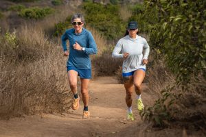 Runners going uphill on dirt road