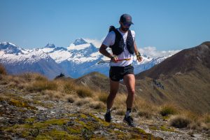 Best Running Vest - runner in Salomon Adv Skin 12 vest on scenic mountain trail