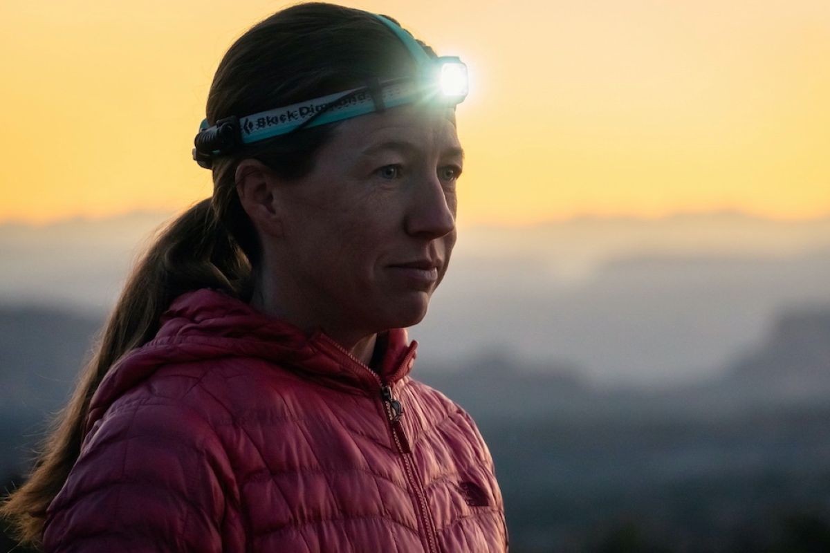 Best Running Headlamp - close-up of runner in headlamp at dawn with mountains in background