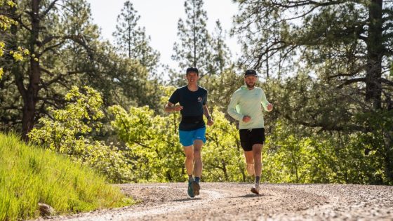 Best Road-to-Trail Shoes - two runners rounding corner on sunny gravel road