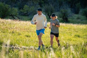 Best Road-to-Trail Shoes - two runners on sunny Colorado trail surrounded by grass