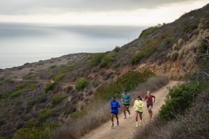 Diverse group of runners on dirt road