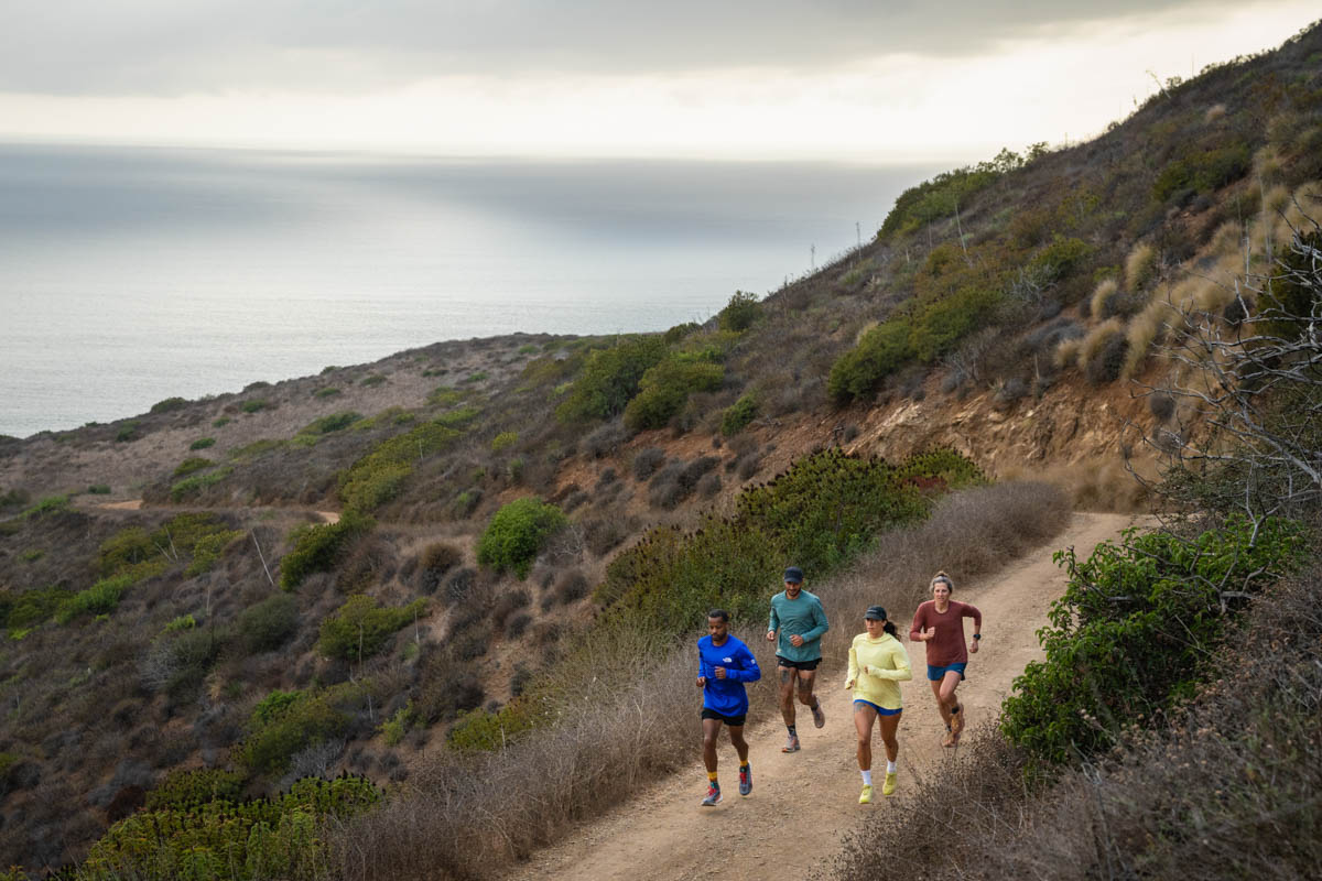 Diverse group of runners on dirt road