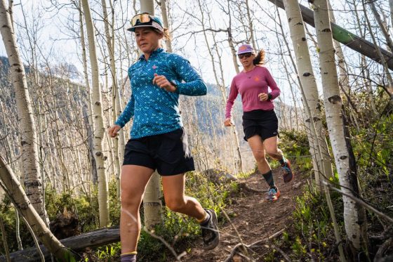 Best Running Hats - two runners in hats going down trail