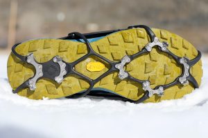 Kahtoola Microspikes Ghost - winter running traction device on snow showing bottom view