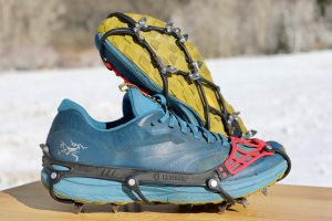 Kahtoola Microspikes Ghost - showing the traction devices on shoes with one underside and one upper showing