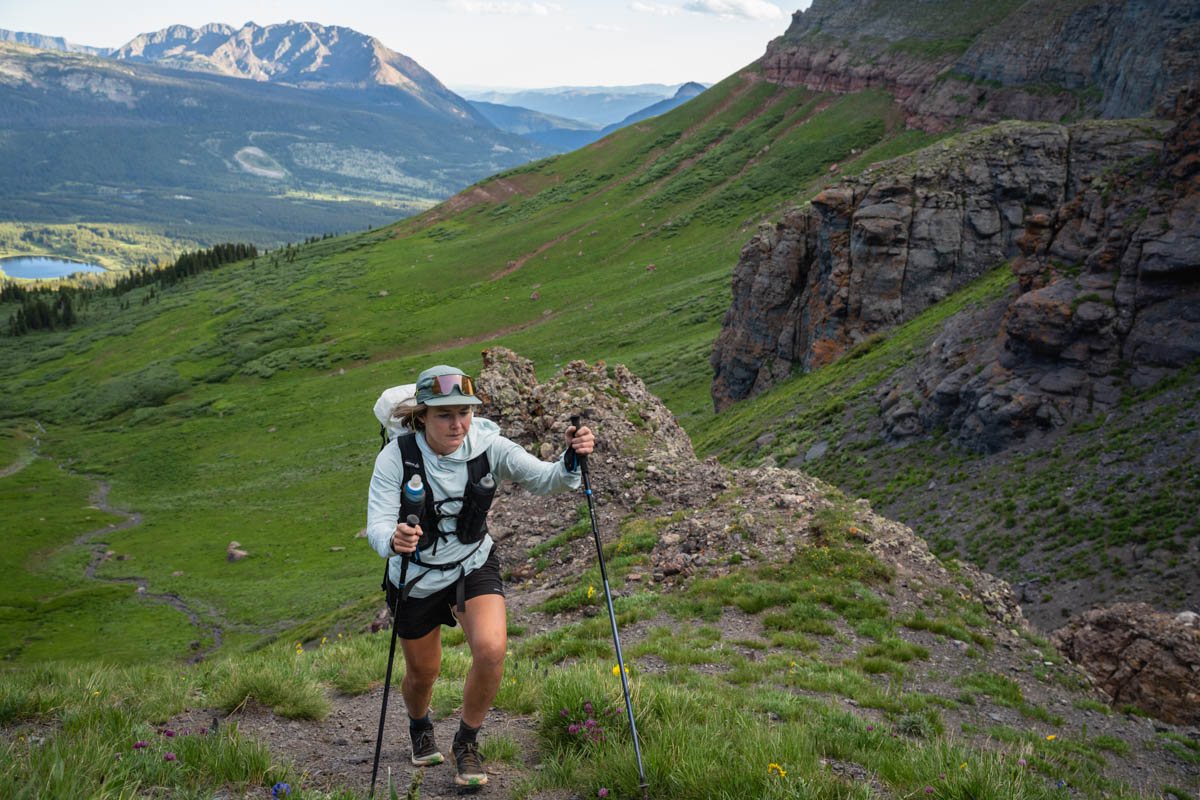 Best Water Filter for Trail Running - runner with trekking poles hiking up climb with Katadyn BeFree 0.6L in running vest