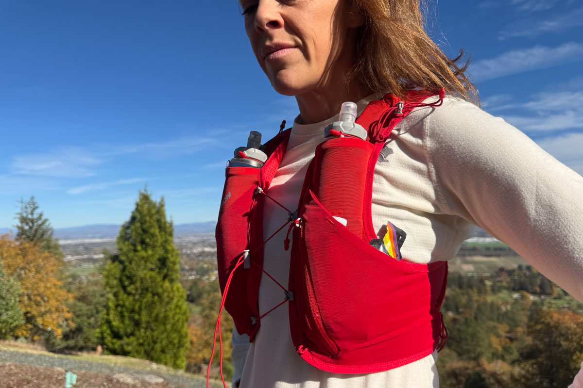 Person outside wearing a hydration pack viewed from the side