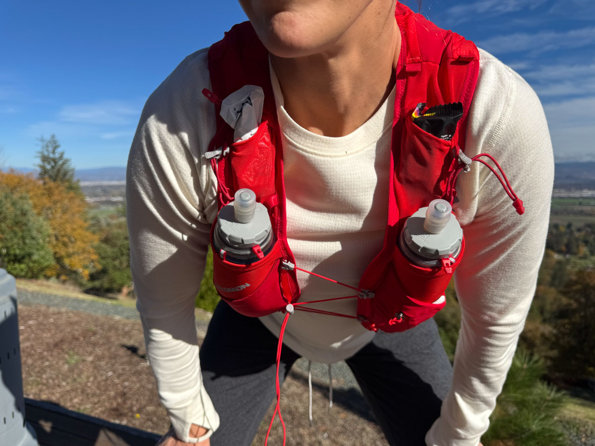 Person outside wearing a hydration pack viewed from front - close up of front pockets