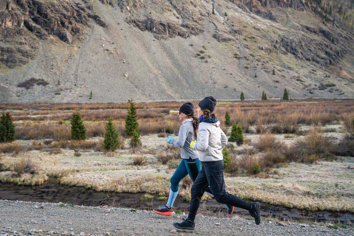 Two women running on dirt road