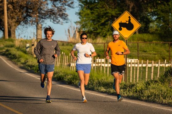 Best Cushioned Running Shoes - three runners on sunny road