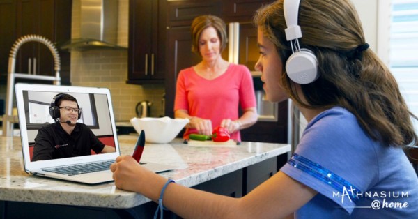 Student working with a math tutor online through a laptop