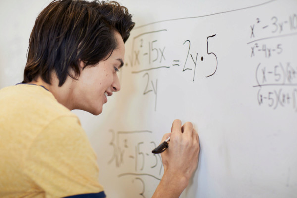 student writing whiteboard