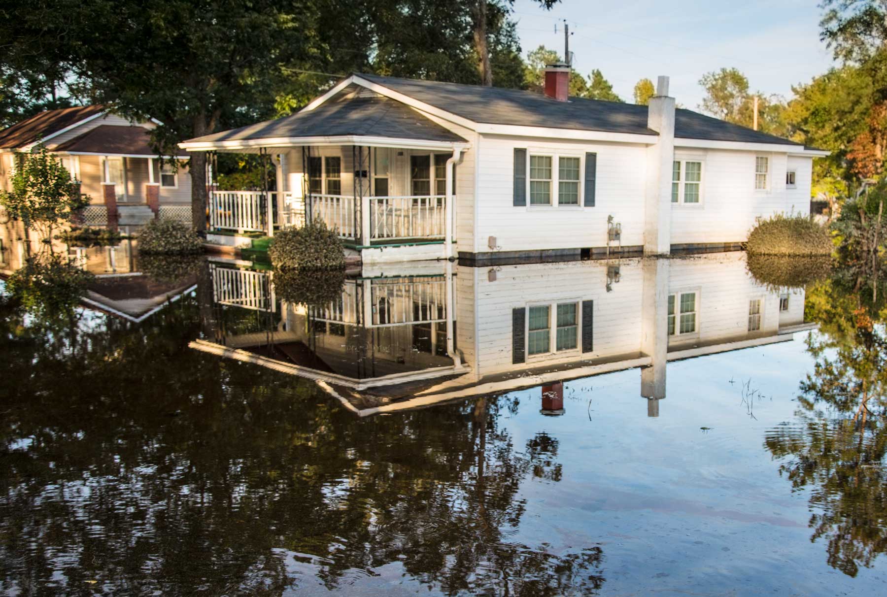 A home’s property is completely inundated under floodwater. (Julie Dermansky)