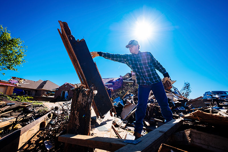 PJ Lewallen clears debris after the storm on May 20, 2017 in Elk City, Oklahoma.