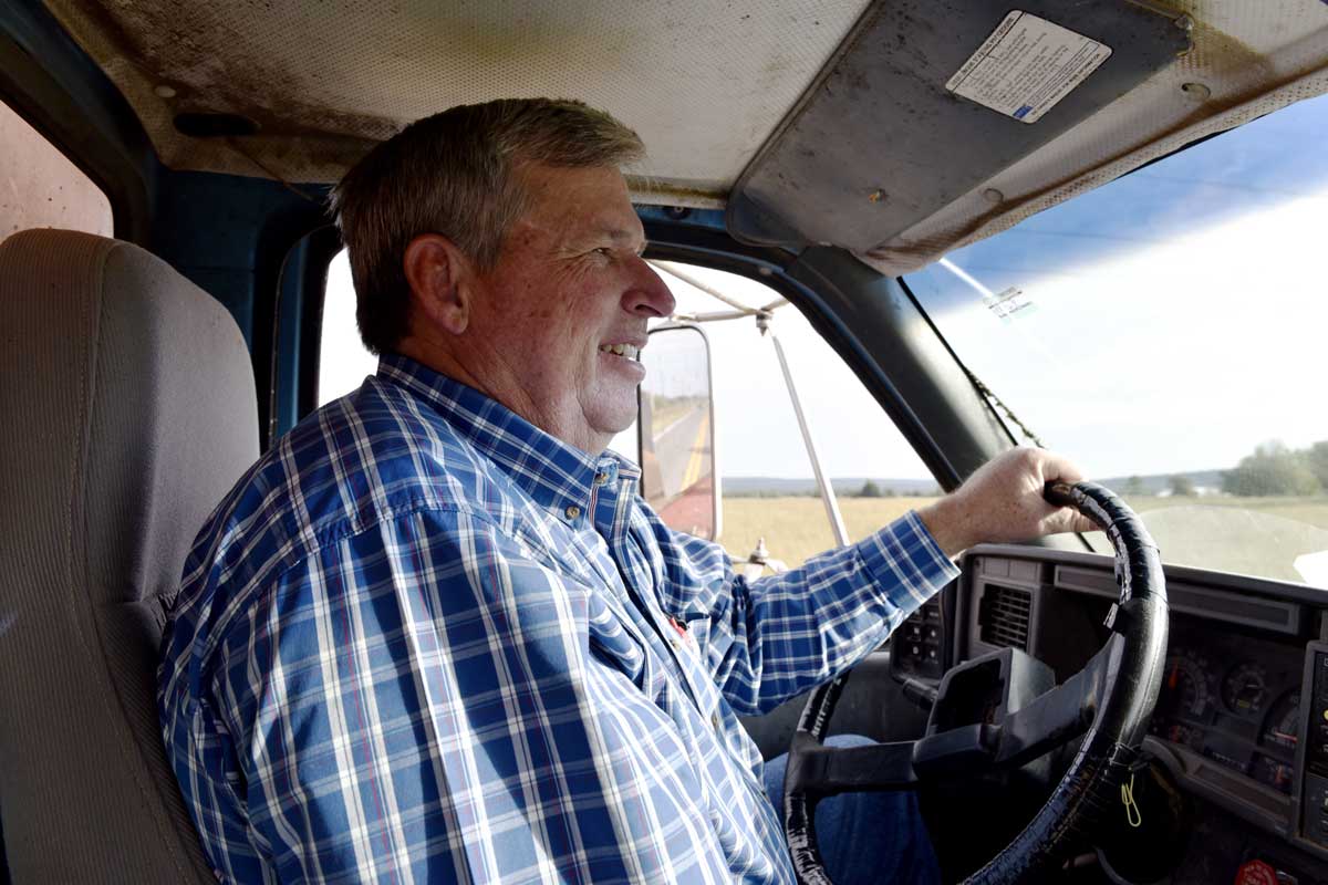 Earl Shero drives a feed truck through a pasture on his ranch in Wilburton. Shero believes that warmer temperatures in Oklahoma are caused by climate change.