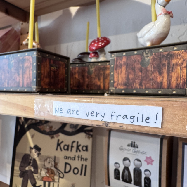 A sign at a booth that says "we are fragile".