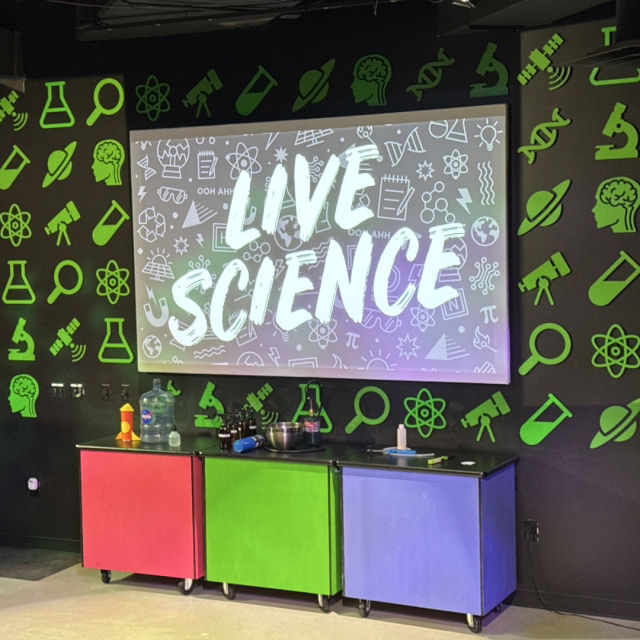 A screen that says "Live Science" at Adventure Science Center