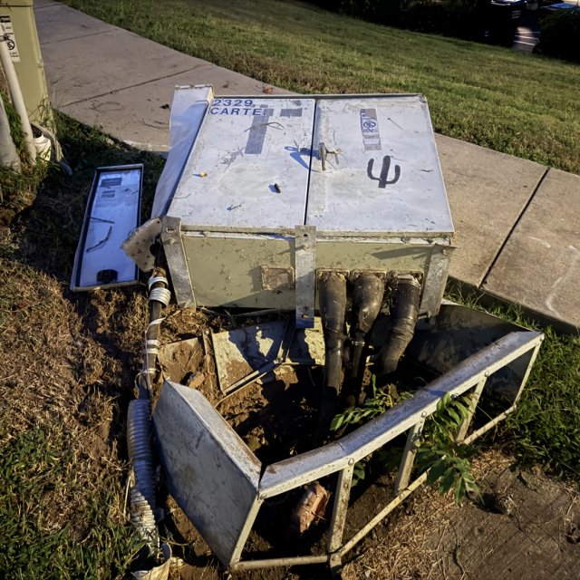 An AT&T communications box, destroyed after being hit by a truck.