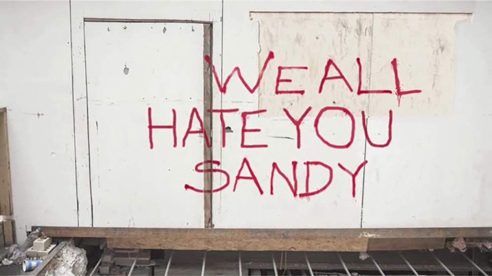 "We all hate you Sandy" graffiti "We all hate you Sandy" graffiti