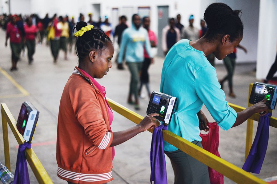 Employees at a textile company in Ethiopia check out after work by fingerprint. Employees at a textile company in Ethiopia check out after work by fingerprint.