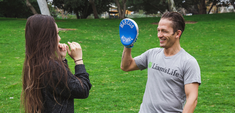 Coach and athlete boxing training outside