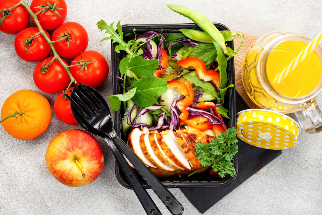 Healthy-meal-prep-containers-with-chicken-and-vegetable-salad