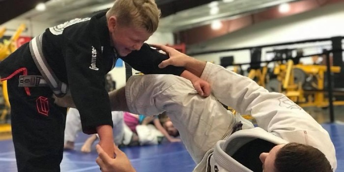 child practicing jiu jitsu skills