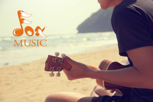 Teen playing Ukulele on beach
