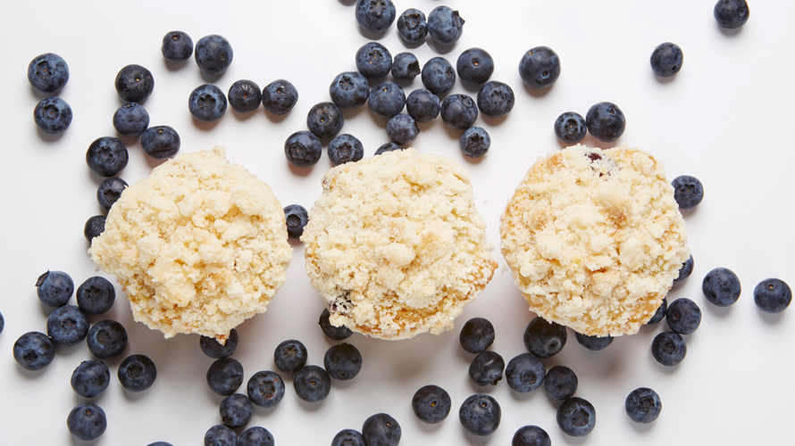 Blueberry muffins with a golden crust, a warm, plump blueberry interior and a delicious crumble on top.