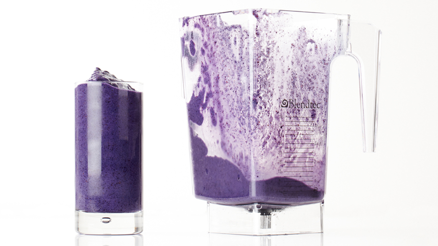 A freshly poured blueberry banana smoothie, vibrant purple in colour.