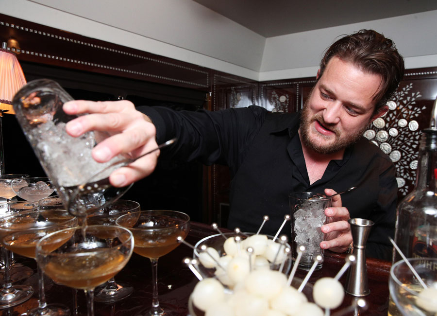 Celebrity bartender Russell Davis of Spike TV pours “The Valet” into martini glasses.